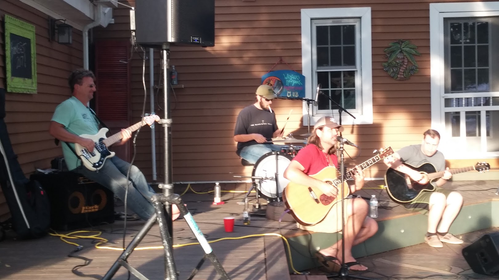 Band of four men playing on the back deck