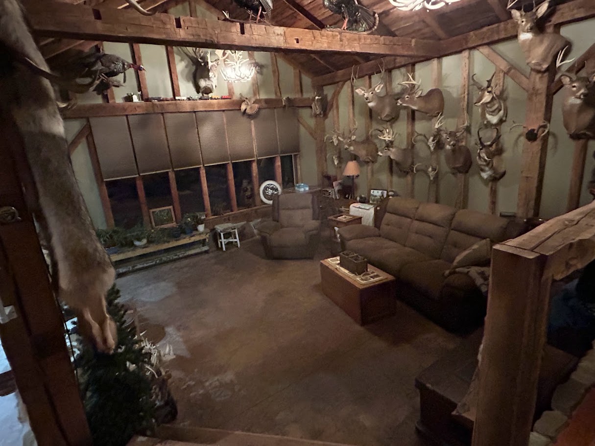 inside great room at the fram house with couches and taxidermy on the walls