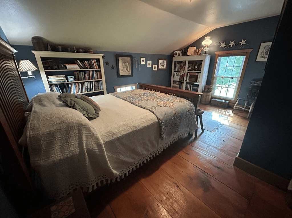 queen bed in a room with blue walls