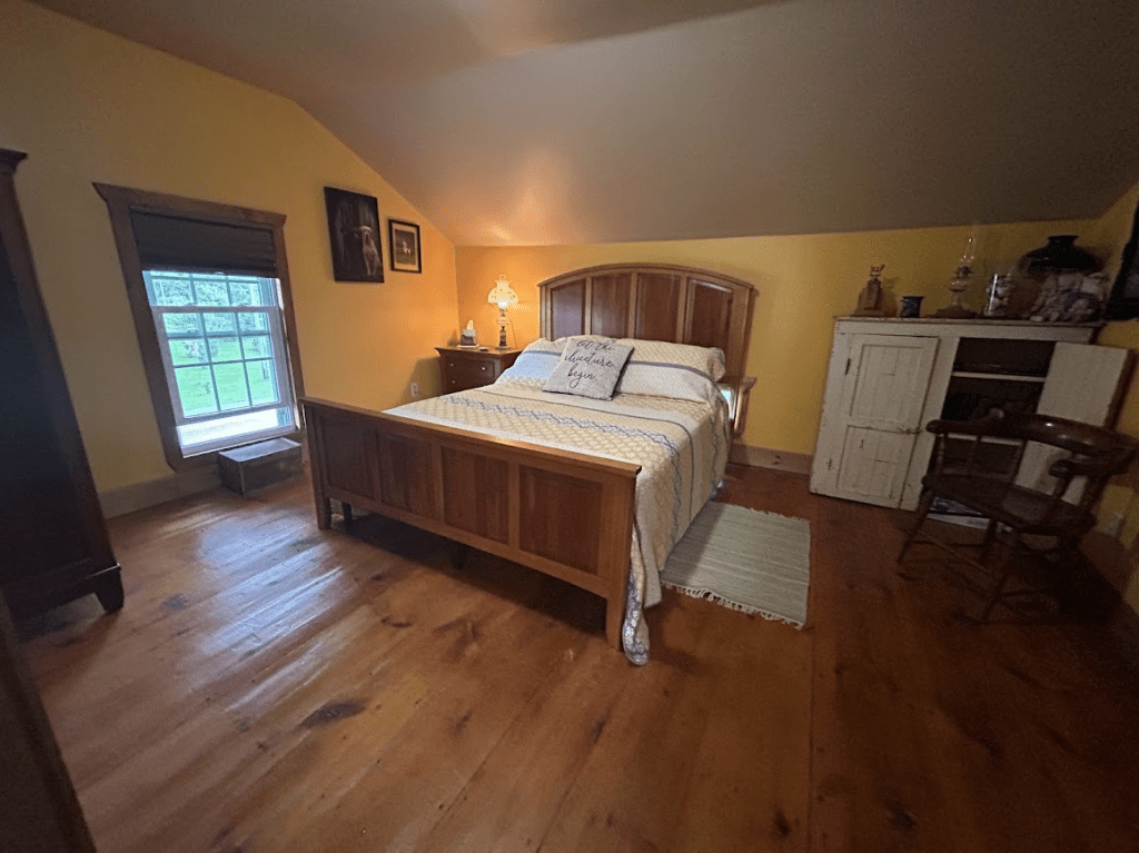 queen bed in a room with yellow walls